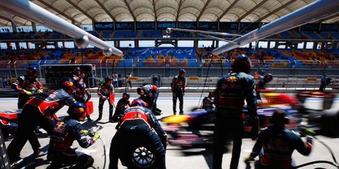 The Toreadors: Red Bull Racing&#8217;s pit crew brings a charging Sebastian Vettel to a halt in Turkey. Photo by Mark Thompson / GETTY