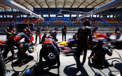 The Toreadors: Red Bull Racing&#8217;s pit crew brings a charging Sebastian Vettel to a halt in Turkey. Photo by Mark Thompson / GETTY