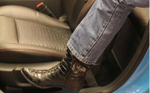 Richard Petty showcases the fact that Legacy by Petty&#8217;s Katzkin leather interior matches his crocodile skin boots.