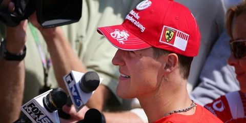 Schumacher, in his familiar garb meeting the masses. How the heck do you pronounce what's on his hat?