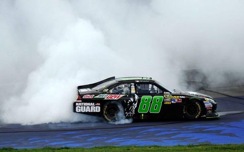 Dale Earnhardt Jr. begins the celebration of a win with a burnout in front of the main grandstands and Michigan International Speedway.