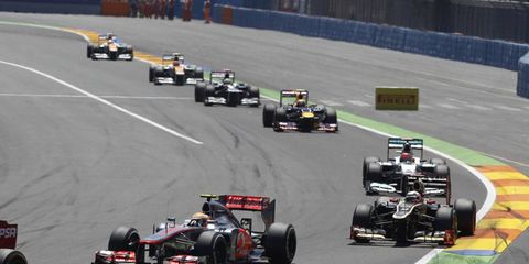 2012 European Grand Prix: Lewis Hamilton, McLaren MP4-27 Mercedes, leads Kimi Raikkonen, Lotus E20 Renault, Michael Schumacher, Mercedes F1 W03, and Mark Webber, Red Bull RB8 Renault.