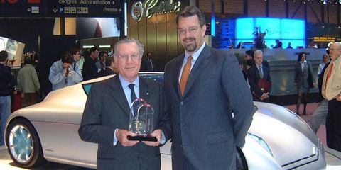 Sergio Pininfarina, left, accepts an Autoweek Editors' Choice Best Concept award from editorial director Dutch Mandel at the 2001 Geneva motor show for the Citro&euml;n Osse, shown in the background.