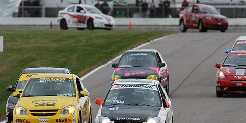 Joel Lipperini holds of John Heinricy early in the Showroom Stock C class at the 2007 Runoffs. Heinricy would win the race.