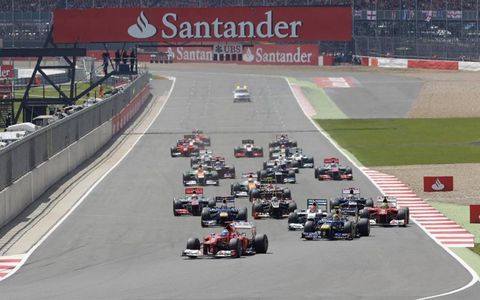 2012 British Grand Prix: Fernando Alonso, Ferrari F2012, Mark Webber, Red Bull RB8 Renault, and the rest of the field charge towards the first corner.