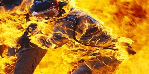 In what looks like an ad for fireproof suits, Benetton mechanic Paul Saby is engulfed in flames after a refueling mishap during the 1994 German Grand Prix at Hockenheim. Driver Jos Verstappen brought this Benetton B194 Ford in for a pit stop, and as the refueler removed the fuel hose, the valve stuck open, allowing fuel to flow out of the nozzle and over the car, which ignited into a huge fireball. (Seaby escaped major injury.)