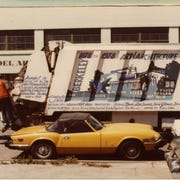 Good thing the Spitfire has the huge 5mph crash bumpers, with that big 1960s Ford parked so close.