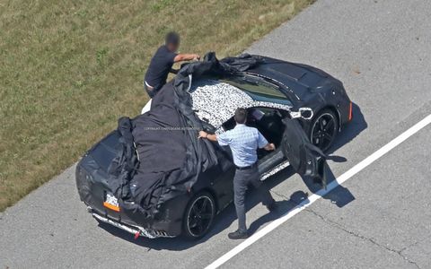 These new spy shots of the mid-engine Corvette show even more detail than before, even as the engineers quickly cover it up after noticing they've been spotted.