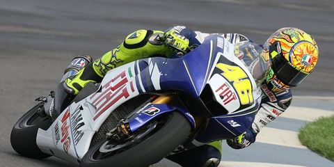 Valentino Rossi battled wind and rain to become the winningest rider in MotoGP history Sunday.