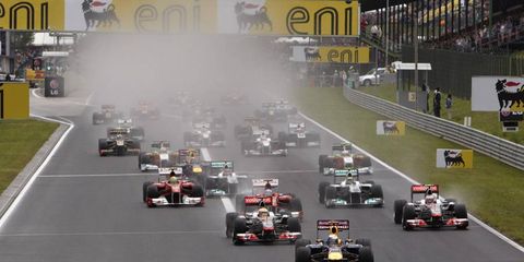 Red Bull Racing&#8217;s Sebastian Vettel leads the Formula One field into turn one at the start of the Hungarian Grand Prix on July 31. Photo by: Steve Etherington/LAT Photographic