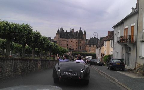 A Jaguar XK120 approaches Chateau de Jumilhac.