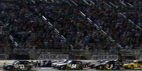 Kevin Harvick fights off Kyle Busch.