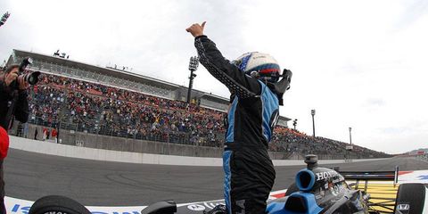 Danica Patrick stands in her car and gives a thumbs up to the crowd at Twin Ring Motegi after winning the Indy Japan 300.