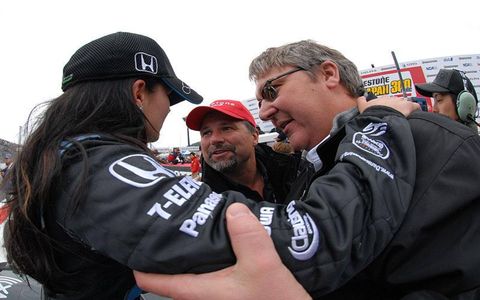 Andretti Green Racing owners Michael Andretti, center, and Kevin Savoree congratulate Danica Patrick on her win.