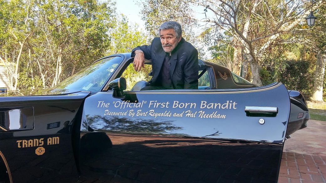 The late Burt Reynolds pictured with the "Bandit" Trans Am.
