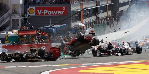 Fernando Alonso goes airborne during a first-lap crash at Spa on Sunday.
