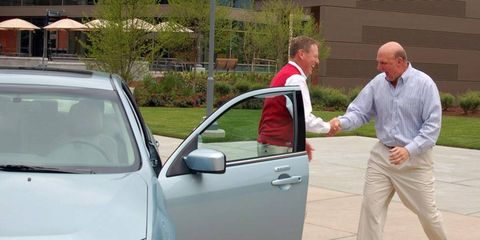 Ford CEO Alan Mulally turns over a 2010 Ford Fusion hybrid with the 1-millionth Sync system to Microsoft CEO Steve Ballmer.