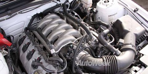 Here's a photo of the new 5.0-liter V8 Ford will use in the 2011 Mustang. It makes 412 hp. Note the intake manifold runners that dive straight into the cylinder heads and a throttle body where the alternator would normally be located.
