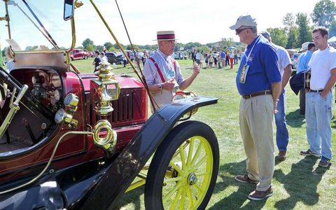 John Linderman of Glastonbury, Conn. explains the intricacies of his 1910 Stanley Model 70 touring steam car to onlookers.