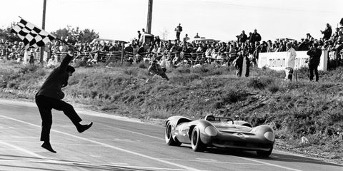 Driving a Lola T70-Chevrolet, Mark Donahue takes the checkered flag at Canada's Mosport Park on Sept. 24, 1966.
