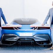 Just two execs and their hypercar. Michael Perschke and Paolo Pininfarina flank the rear end of the Pininfarina Battista.