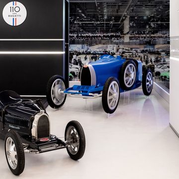 A vintage Bugatti Baby with a 3D-printed model of the upcoming, larger (but still small) Baby II on the floor of the 2019 Geneva motor show.