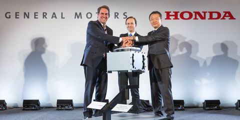 General Motors Executive Vice President Global Product Development Mark Reuss (l-r), Michigan Lt. Governor Brian Calley and Honda CEO North American Region and President Honda North America Toshiaki Mikoshiba announce a manufacturing joint venture to mass produce an advanced hydrogen fuel cell system that will be used in future products from each company.