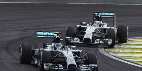 Nico Rosberg, left, is expecting a race-long battle with Mercedes teammate Lewis Hamilton, right, at Abu Dhabi.