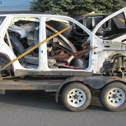 What's left of the wrecked 2008 Trailblazer that gave its engine to my '41 Plymouth project, on its way to the scrapper.