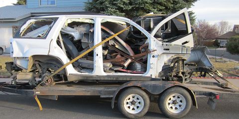 What's left of the wrecked 2008 Trailblazer that gave its engine to my '41 Plymouth project, on its way to the scrapper.