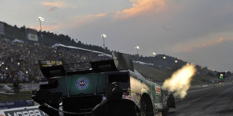 John Force claimed the provisional top qualifying spot in Funny Car for the Mile High Nationals with a record run on Friday night near Denver.
