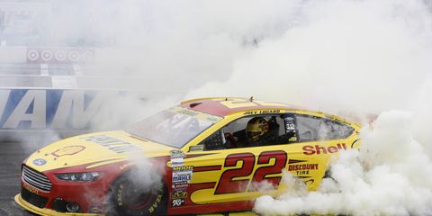 Joey Logano joined Team Penske teammate Brad Keselowski as qualifiers for the second round of the NASCAR Chase with his win at New Hampshire Motor Speedway on Sunday.