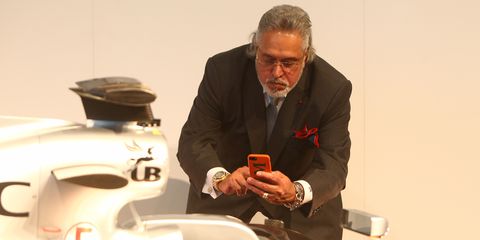 Vijay Mallya, team principal and managing director of Force India, takes a picture of the VJM10.