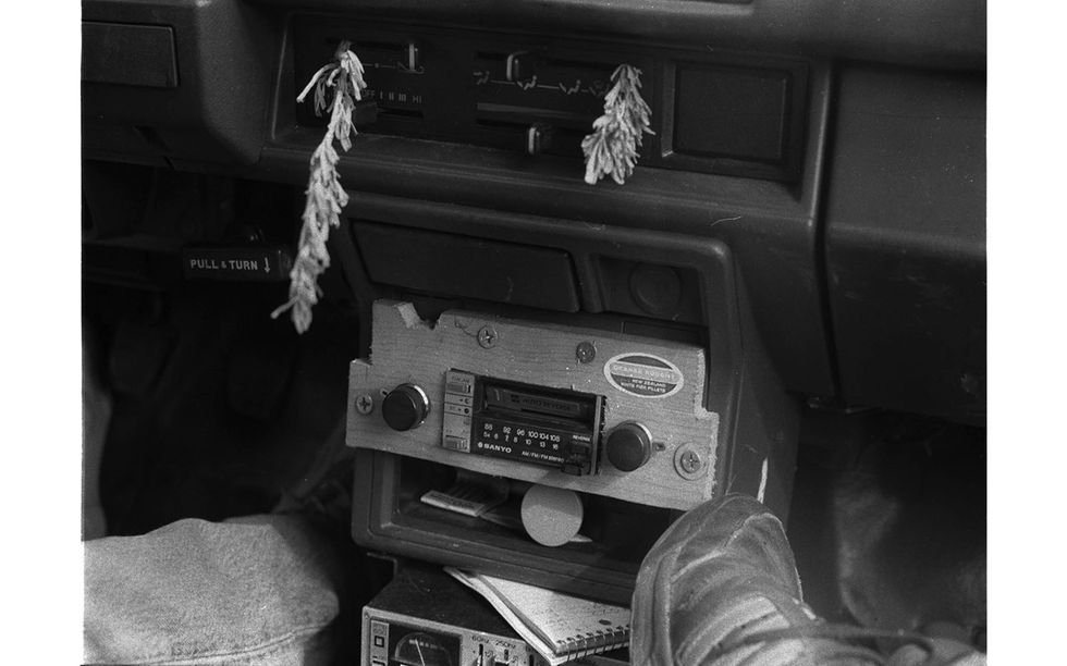 Sagebrush stuck in the heater controls, junkyard cassette deck in crude wooden faceplate.