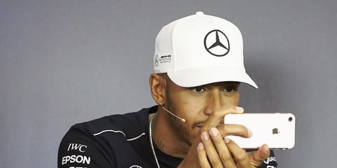 Lewis Hamilton uses his phone during a press conference at the Austrian Grand Prix.