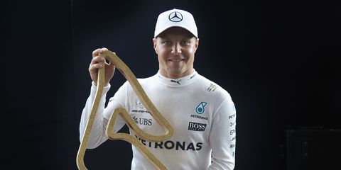 Valtteri Bottas poses with his winner's trophy from the Austrian Grand Prix.