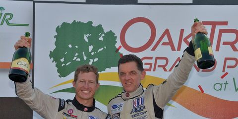Level 5 Motorsports owner and driver Scott Tucker (right) with driver Ryan Briscoe following their P2 win at Virginia International Raceway in 2013.