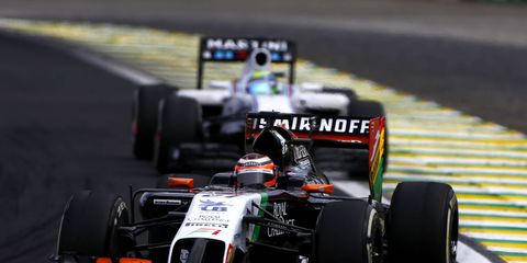 The Smirnoff sponsored Force India car leading the Martini sponsored Williams' car at the Brazilian Grand Prix.