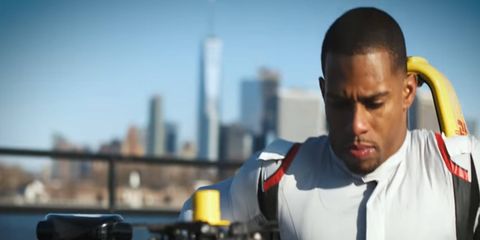 Victor Cruz, all 6-foot, 204 pounds of him, squeezes into the cockpit of a Formula E car.