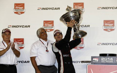 Will Power holds up this trophy.