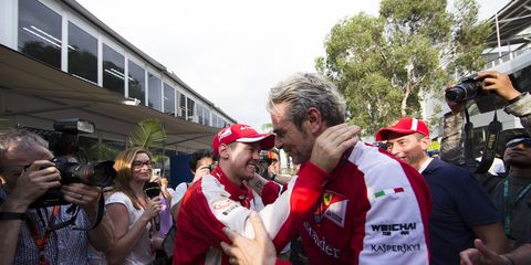 Ferrari boss Maurizio Arrivabene embraces driver Sebastian Vettel after Vettel's victory in Malaysia last week. After the big win, Arrivabene received an emotional message from Michael Schumacher's manager that brought him to tears.