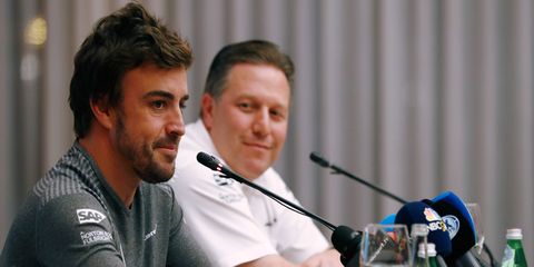 Fernando Alonso, left, and McLaren director Zak Brown discuss Alonso's deal to race at Indianapolis.