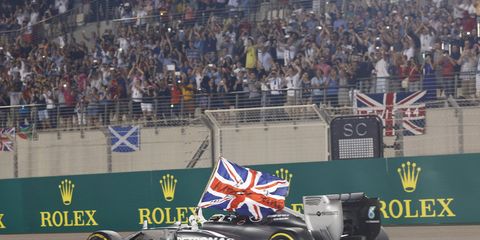 Lewis Hamilton displays a Union Jack as he does a victory lap.