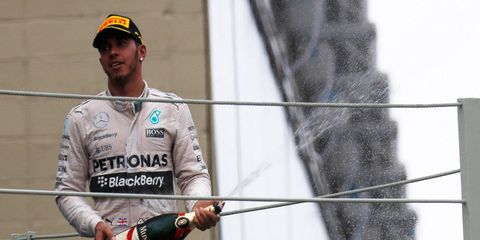 2015 Formula One champion Lewis Hamilton celebrates with Mumm champagne in Brazil in November.