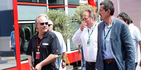 Haas F1 Team owner Gene Haas, left, and team principal Gunther Steiner, right, tour the paddock in Barcelona.