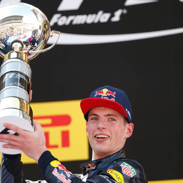 Verstappen proudly hoists the first place trophy on the podium in Spain.