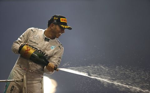 Lewis Hamilton celebrates after winning the F1 championship.