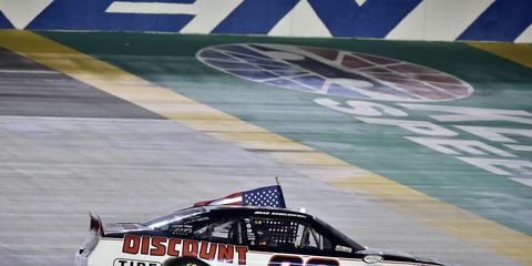 Brad Keselowski does the customary burnout to celebrate his victory by 0.241 second over Erik Jones on Friday night in Kentucky.