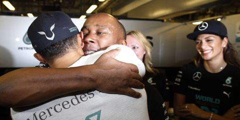 Anthony Hamilton hugs son Lewis after the 2014 World Championship. The elder Hamilton wants Formula One to return to Africa.