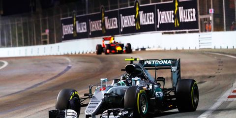 Mercedes' Nico Rosberg holds off Red Bull's Daniel Ricciardo for the Formula 1 win in Singapore.